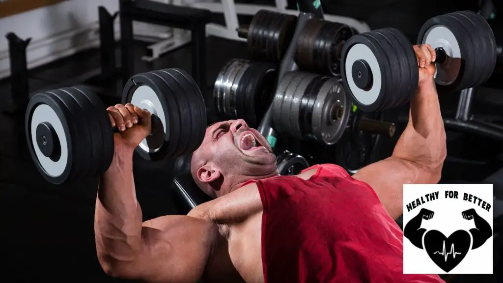 guy in red shirt dumbbell press