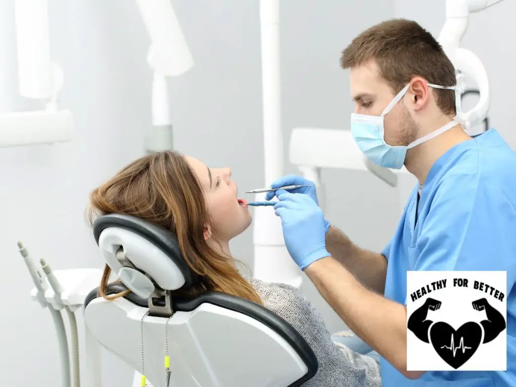 girl getting tooth extracted by dentist