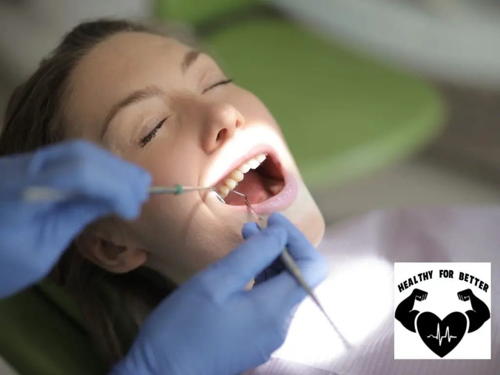 girl getting tooth extracted by dentist